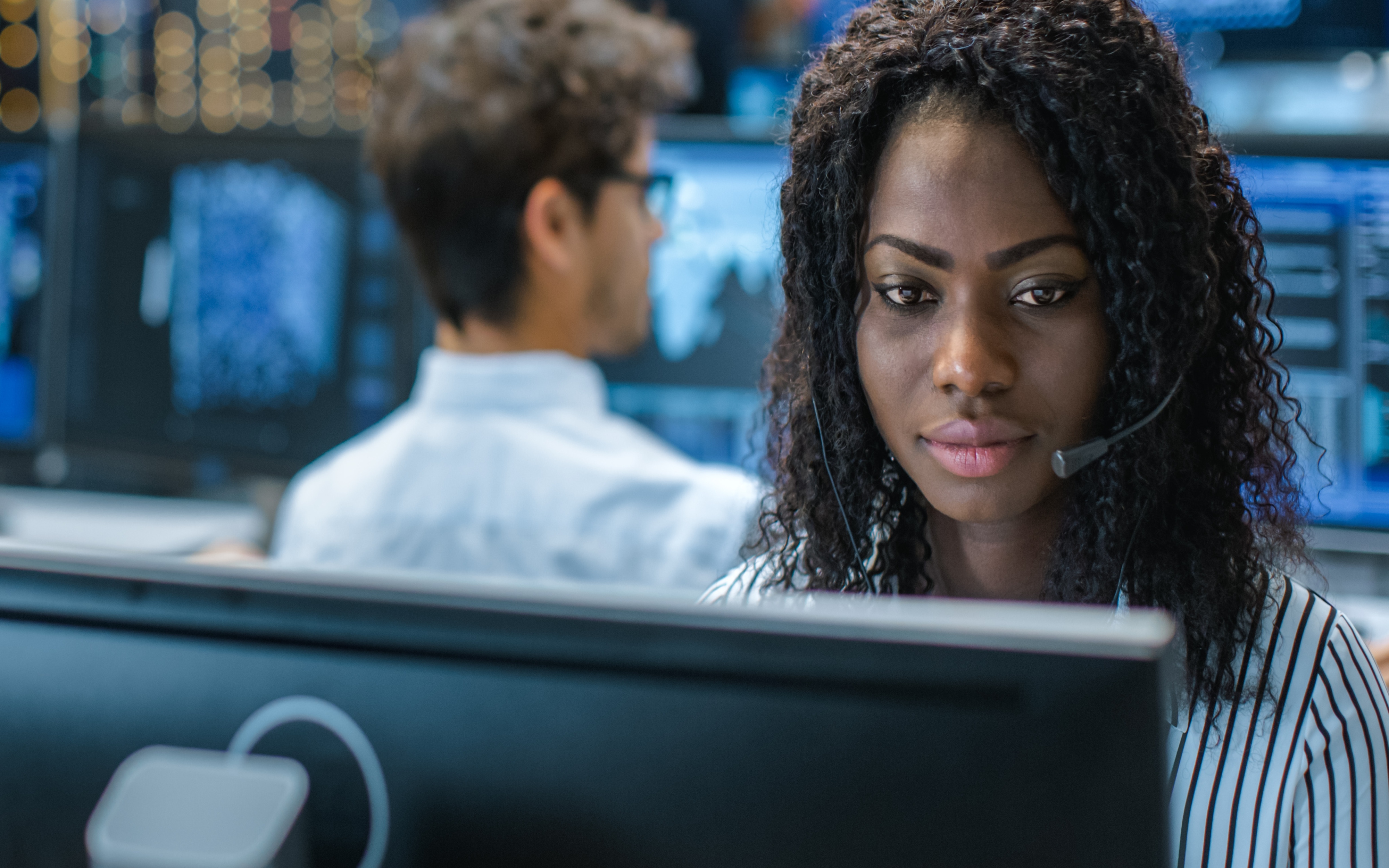 Woman Sitting at Computer Desk With Headset On