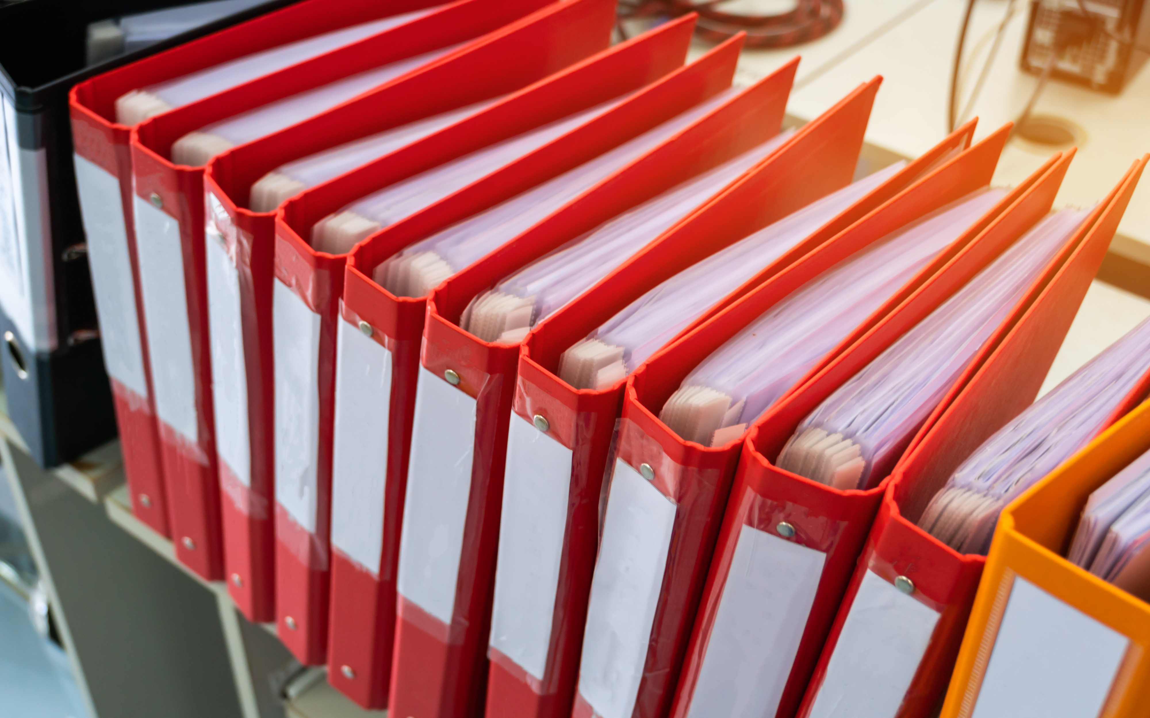 Binders on Shelf Filled with Documents